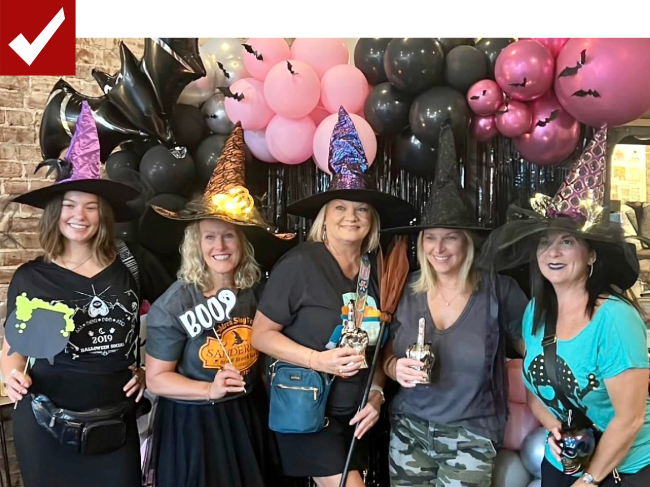 Ladies dressed in witch costumes